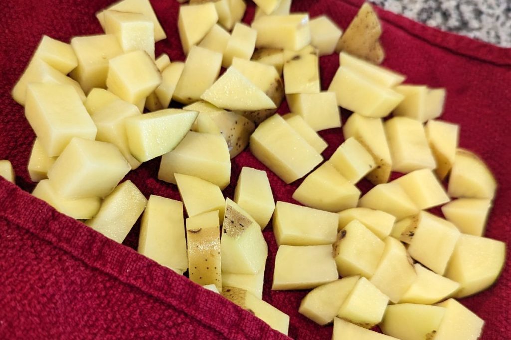 This is diced potatoes on a towel.