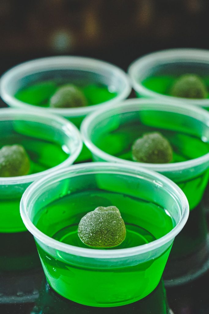 This is a closeup of green apple jello shots.