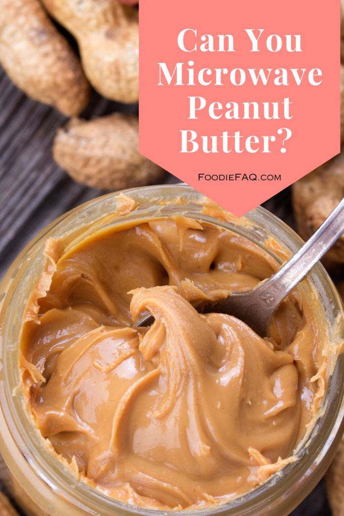 This is an open jar of peanut butter with a spoon.